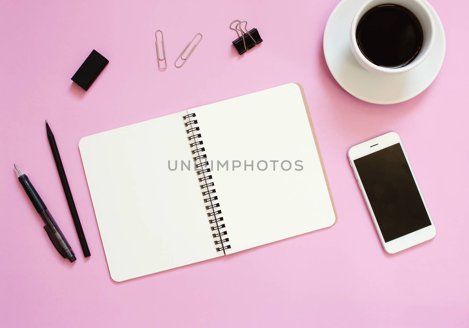 Creative flat lay mockup design of workspace desk with blank notebook, smartphone, coffee, stationery with copy space background

