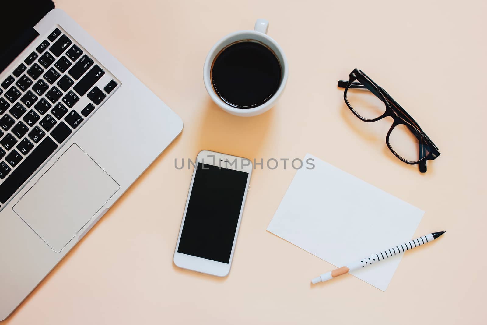 Creative flat lay photo of workspace desk with laptop, smartphone, coffee and blank paper with copy space background, minimal style
