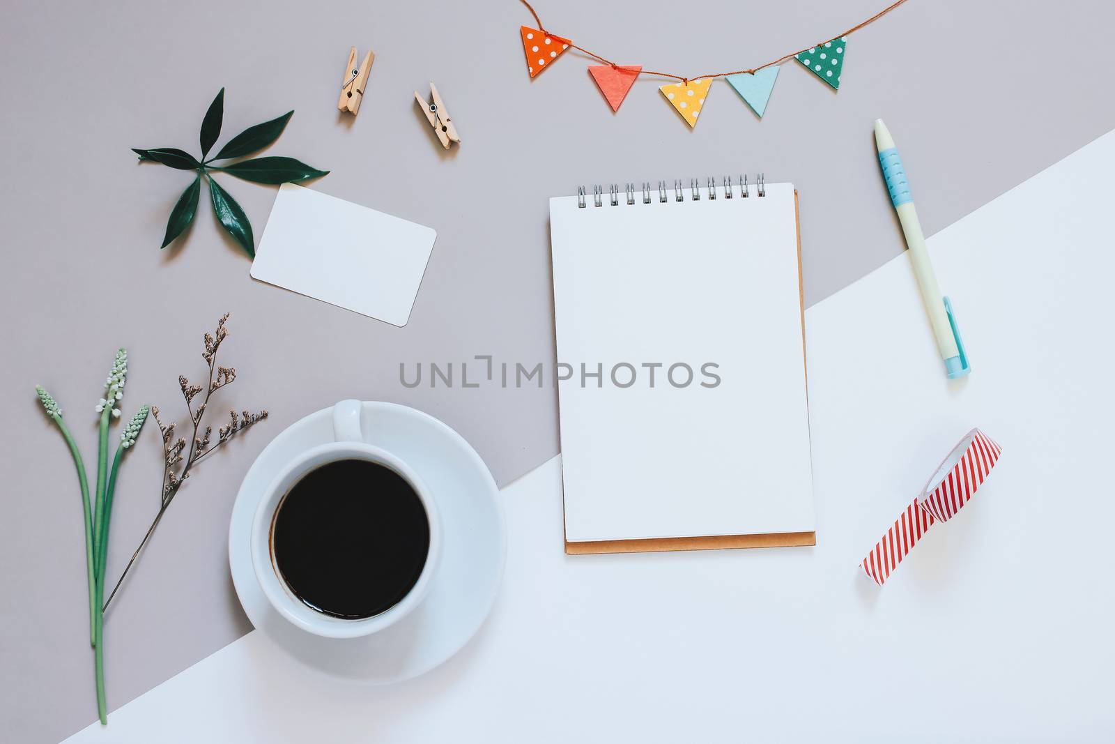 Creative flat lay photo of cute workspace desk with notebook, coffee, name card and decorated cute craft with copy space background, minimal style
