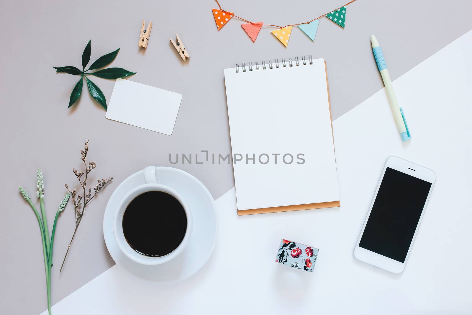 Creative flat lay design of cute workspace desk with notebook, coffee, smartphone and decorated cute craft with copy space background, minimal style
