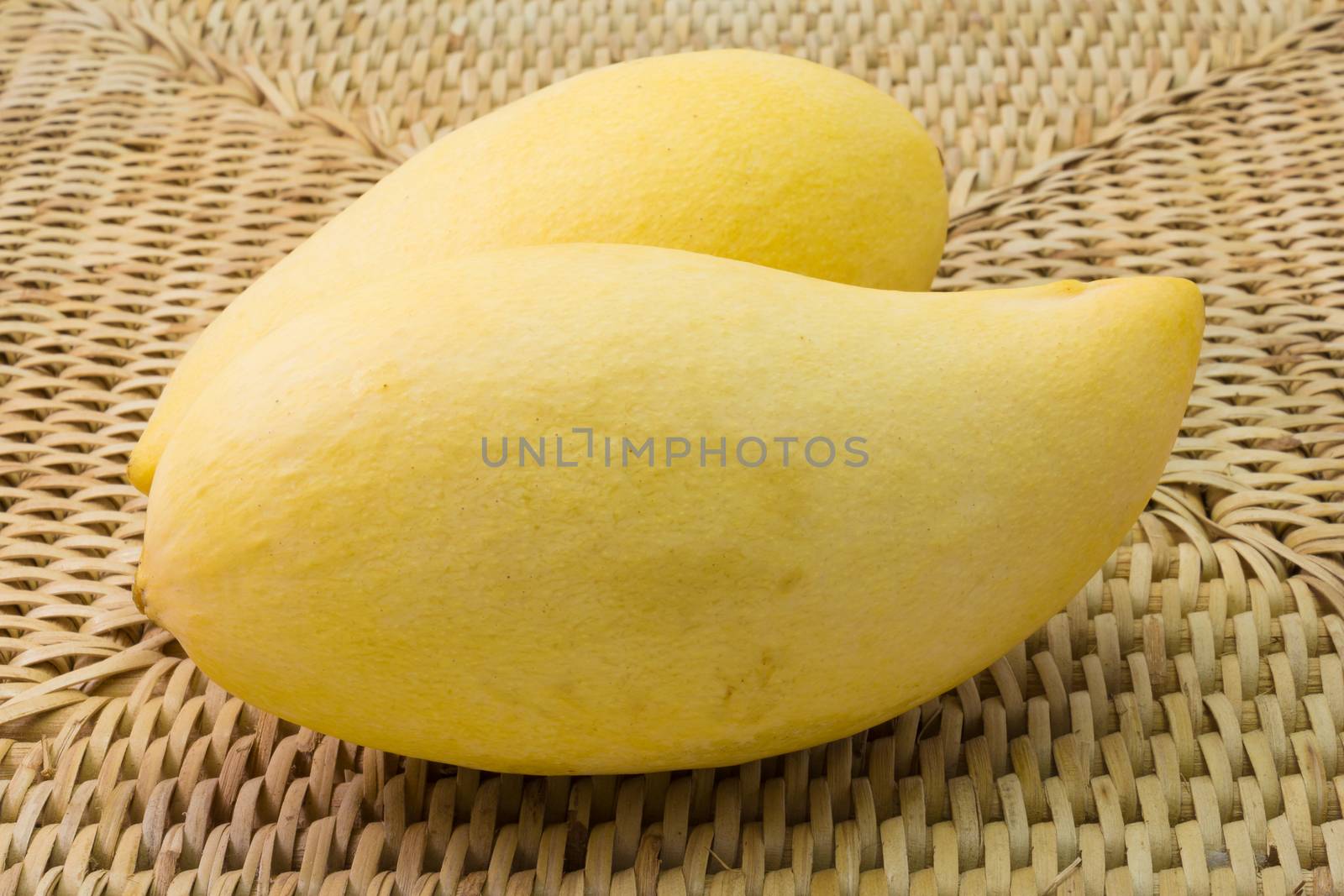 fresh delicious yellow mango in wood plate