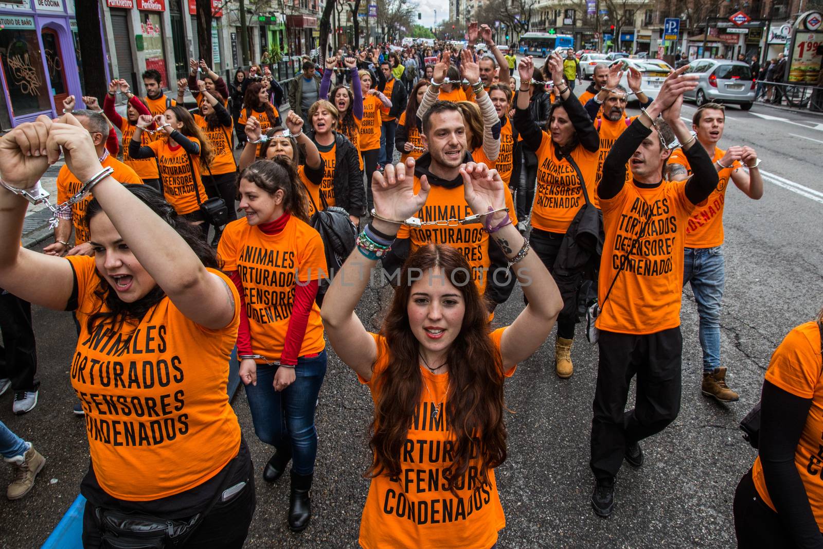 SPAIN, Madrid : Protesters sporting handcuffs march during demonstration in support of pro-animal rights activists, in Madrid on April, 16, 2016. 