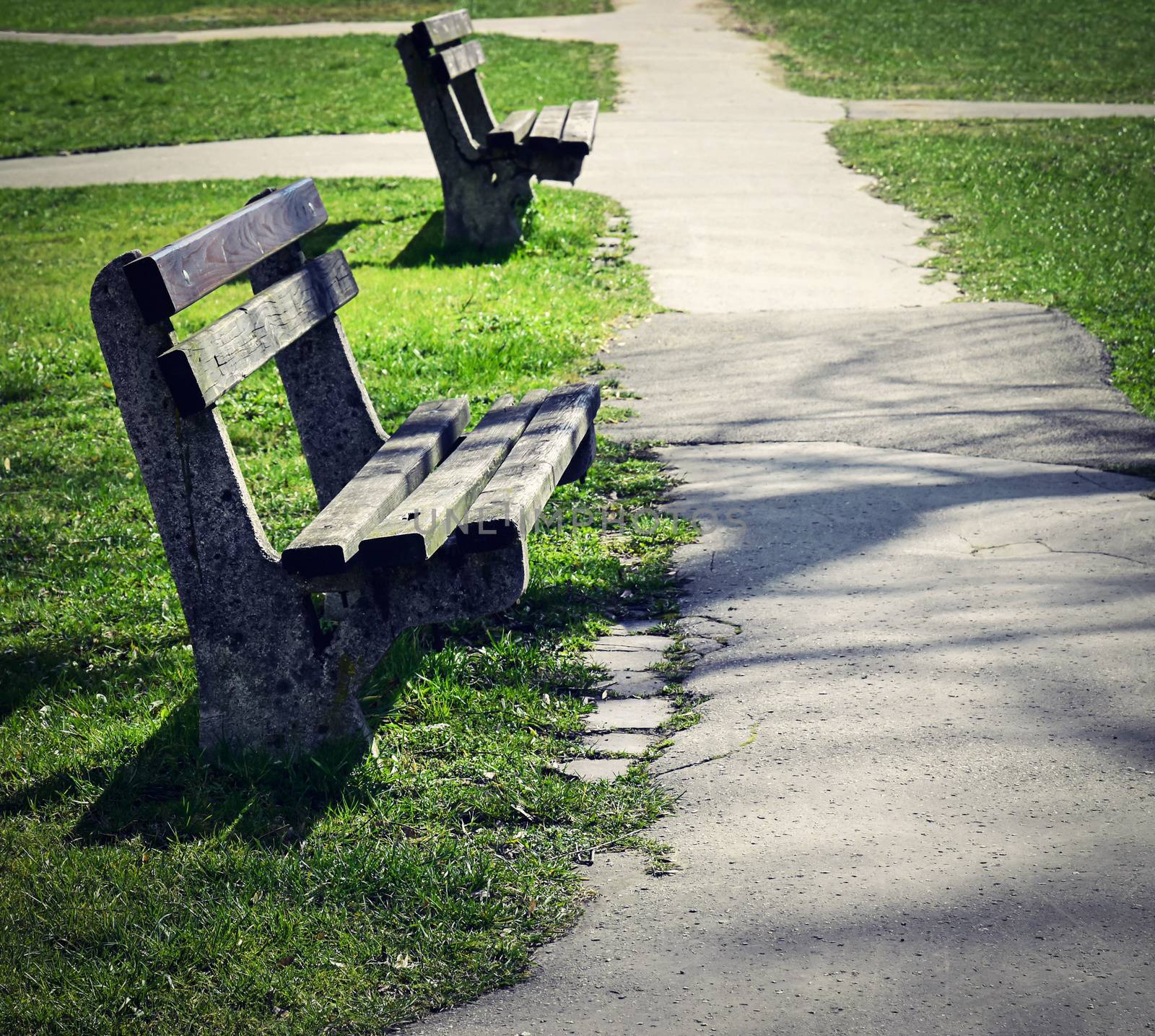 background two old abandoned benches in park