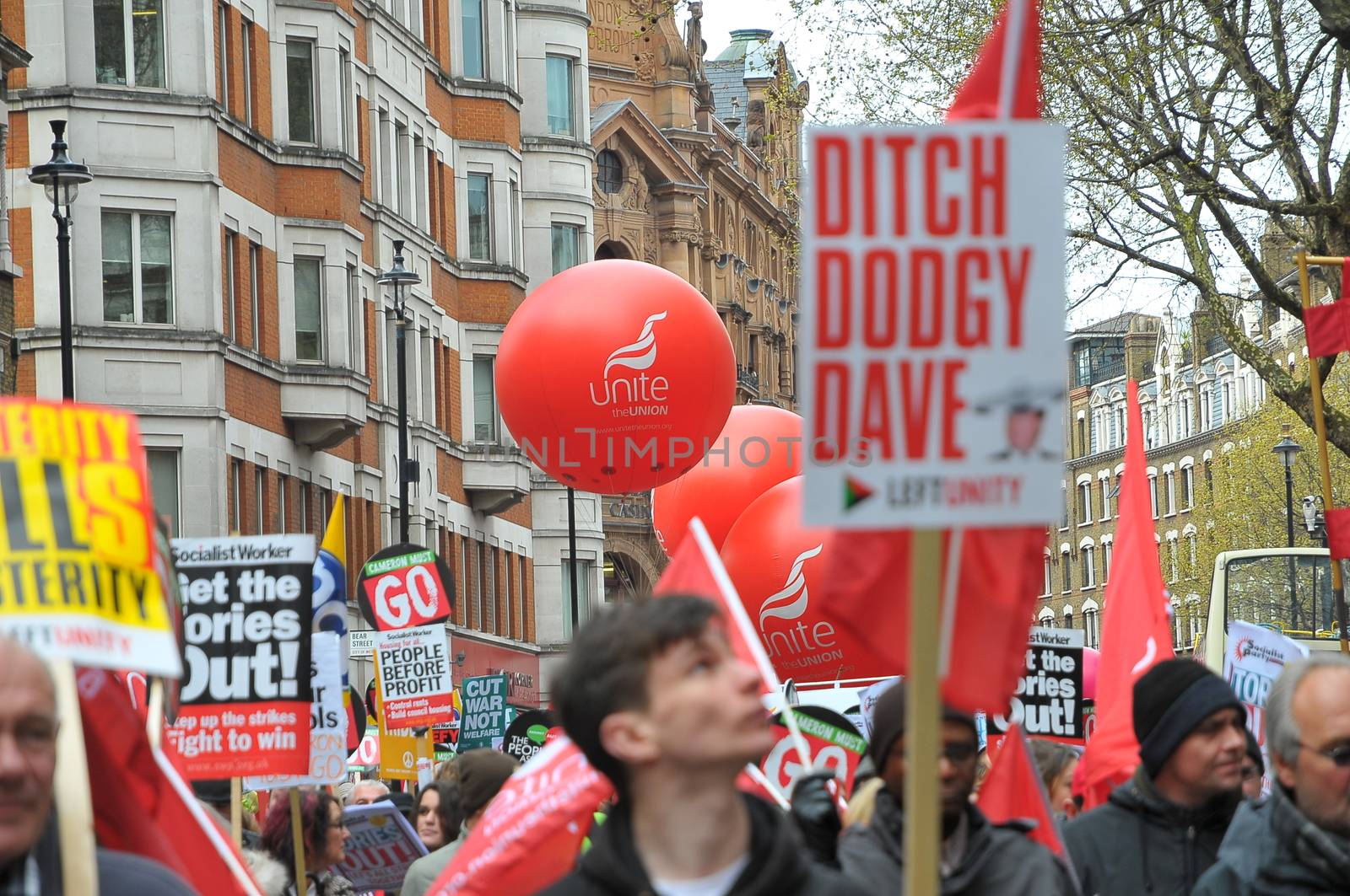 UNITED KINGDOM, London: A protester holds a sign reading 'Ditch Dodgy Dave' as ten of thousands march and protest against the Tories government and demanded David Cameron's resignation in Trafalgar square in London on April 16, 2016. Protesters descended to London in hundreds of coaches from all over the UK to take part in this anti-austerity protest.