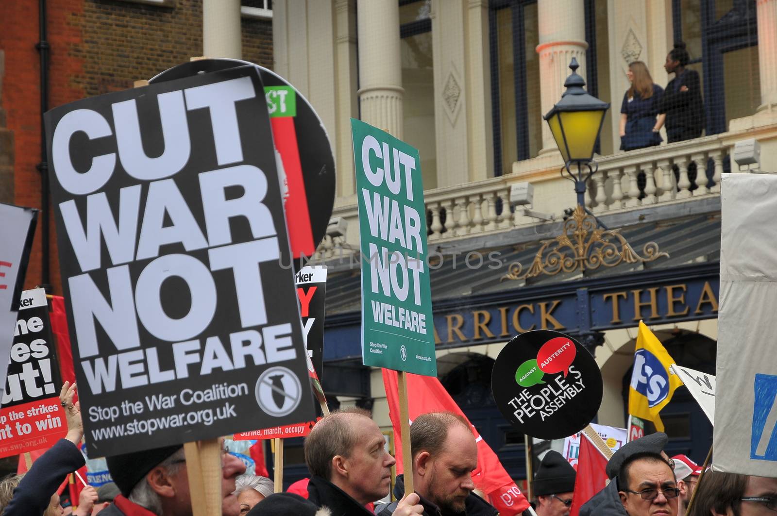 UNITED KINGDOM, London: A protester holds a sign reading 'Cut war not welfare' as ten of thousands march and protest against the Tories government and demanded David Cameron's resignation in Trafalgar square in London on April 16, 2016. Protesters descended to London in hundreds of coaches from all over the UK to take part in this anti-austerity protest.