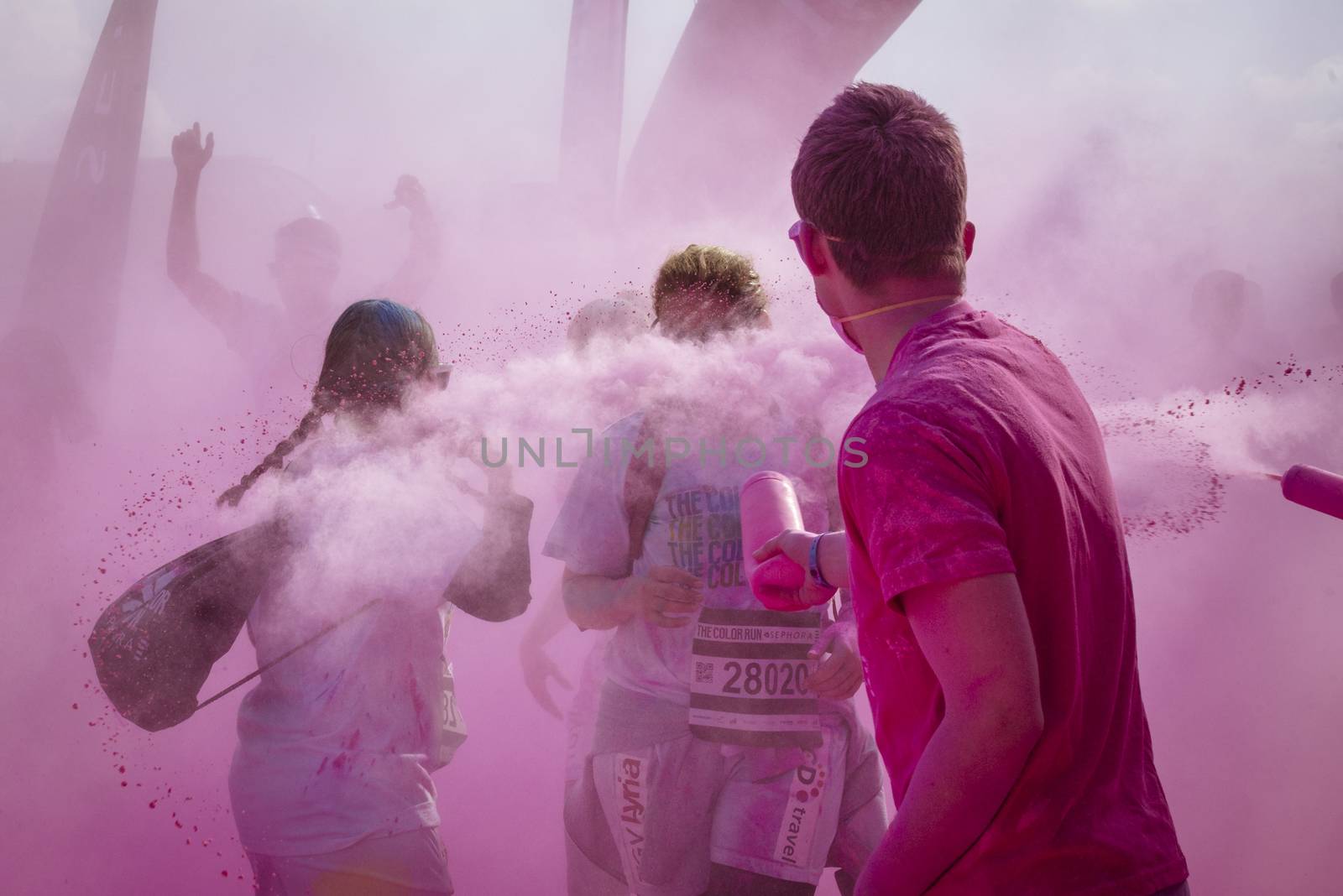 France: A volunteer throws colored pigments at participants of the Color Run by Sephora in Paris on April 17, 2016.