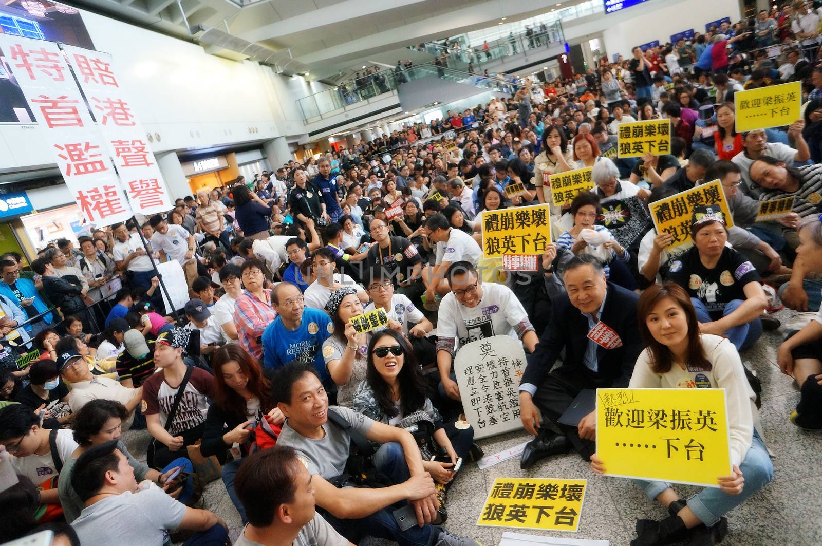 HONG KONG: Protesters hold signs during a protest organised by the Hong Kong Cabin Crew Federation at Hong Kong International Airport on April 17, 2016.More than 1,000 people protested at the city's airport on April 17 over an incident that saw the daughter of the city's leader had her forgotten hand baggage delivered to her at the restricted airport area.