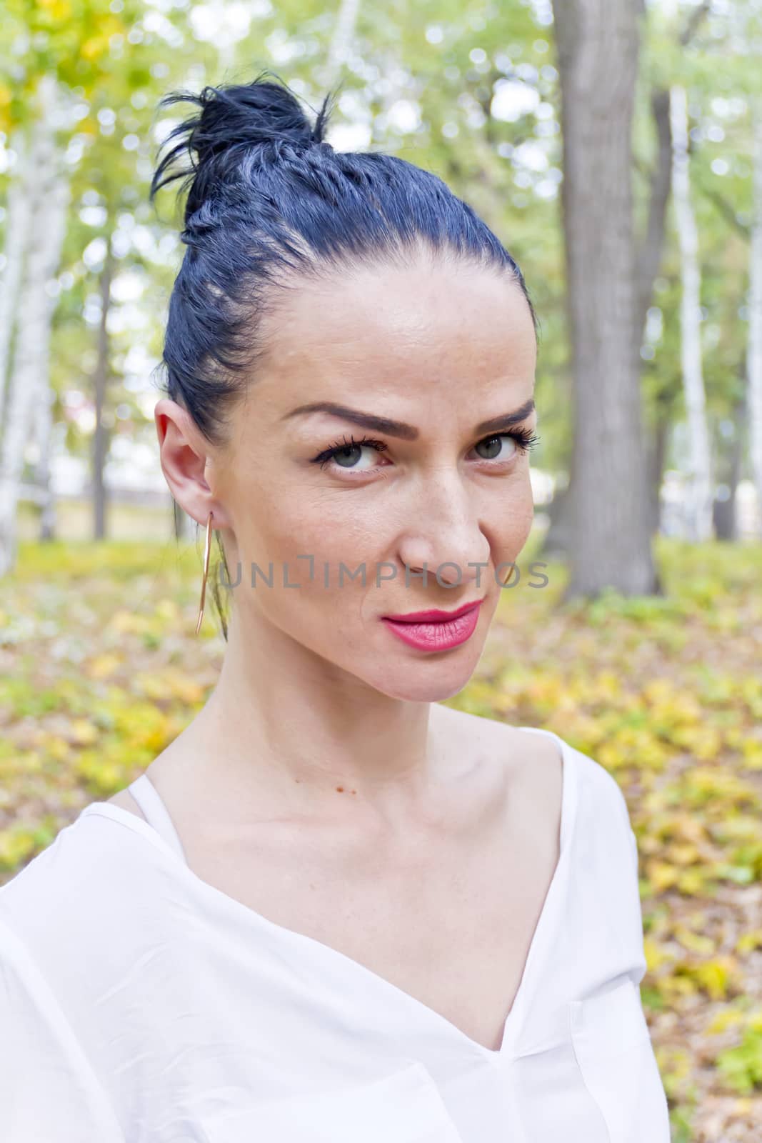 Portrait of Caucasian brunette in autumn park