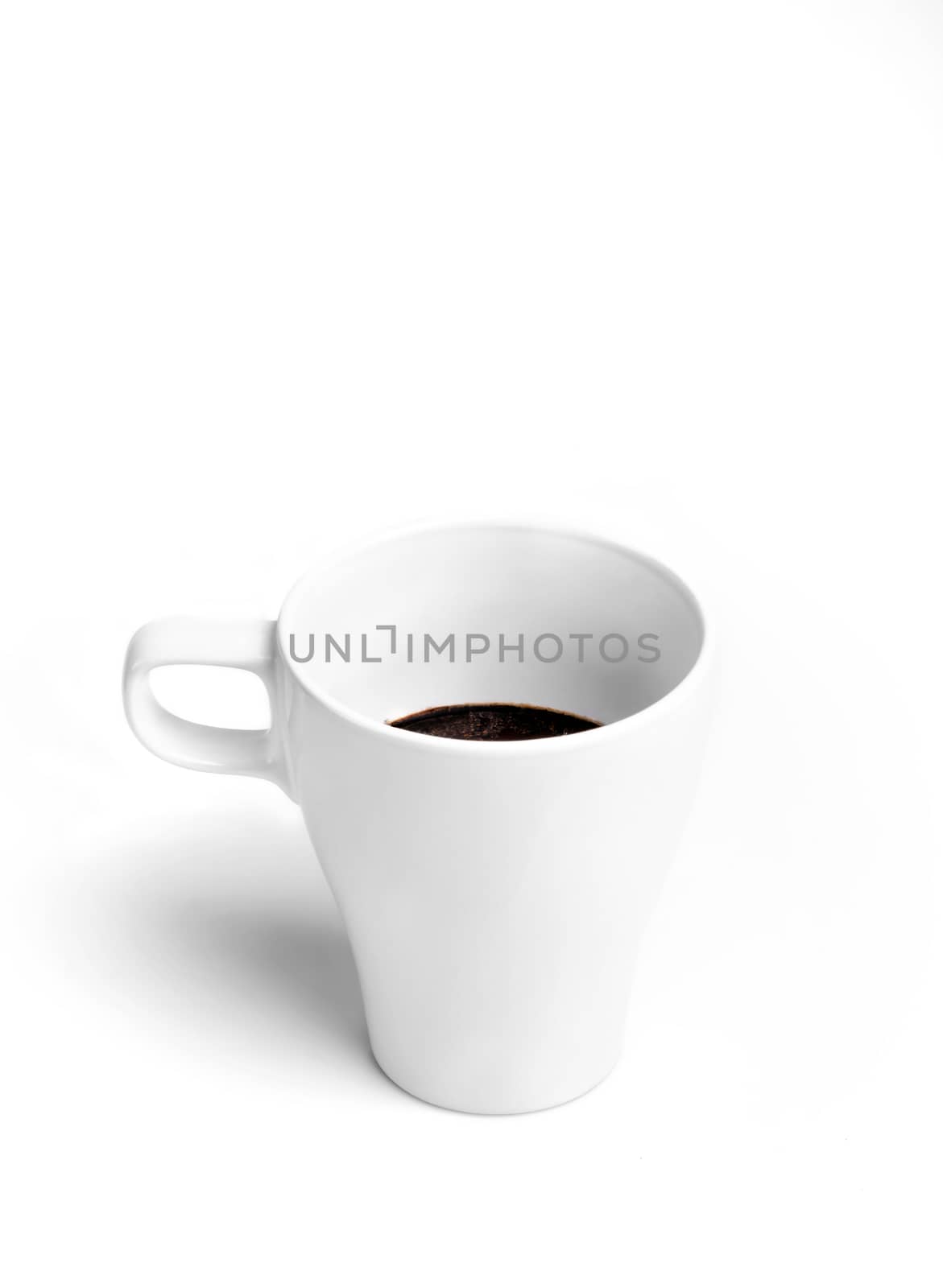 White porcelain half full cup of tasty morning coffee isolated on white background.
