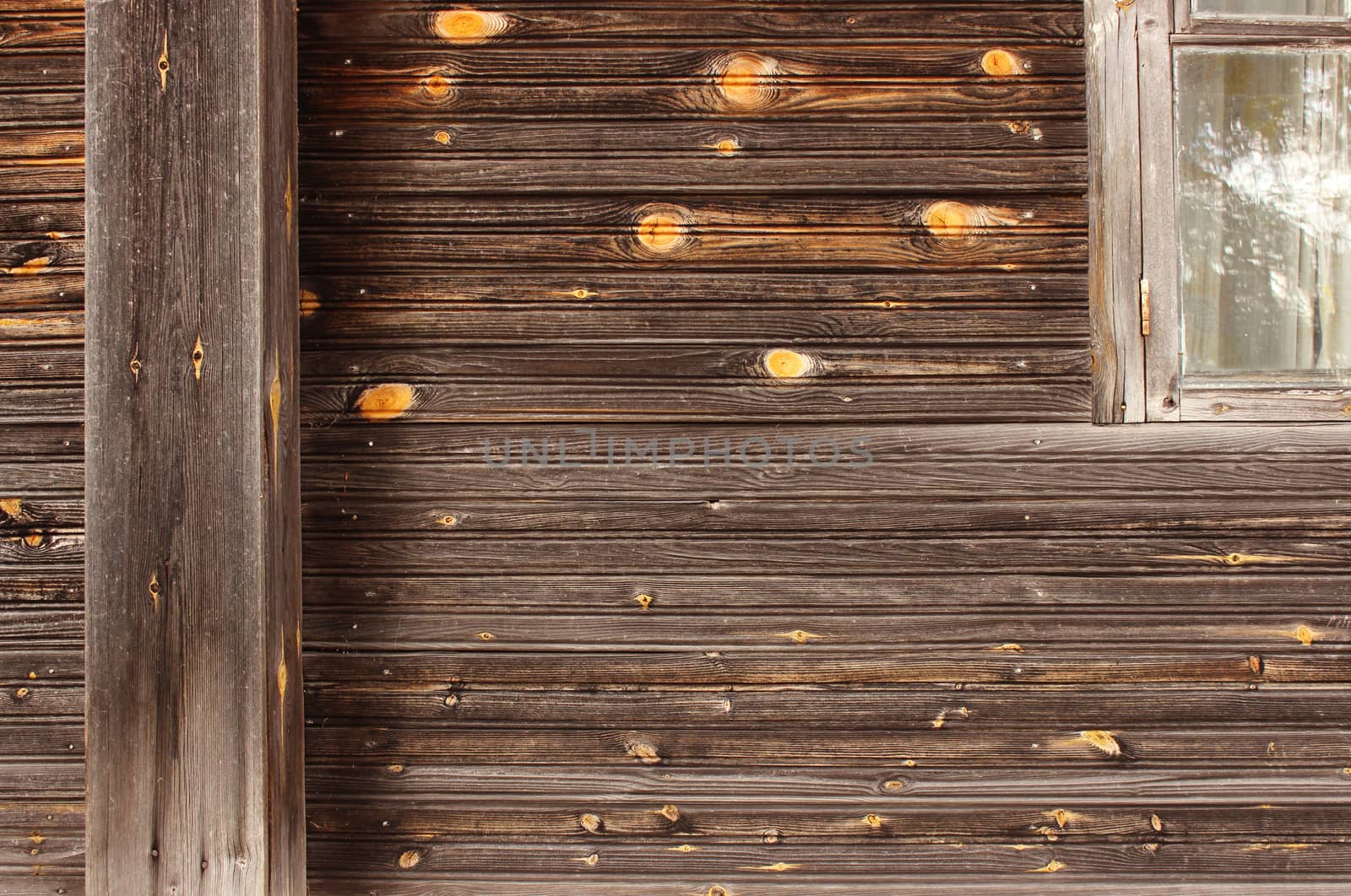 The texture of pure wood on the wall of an ordinary old wooden house, village Nizovskaya, Leningrad region, Russia.