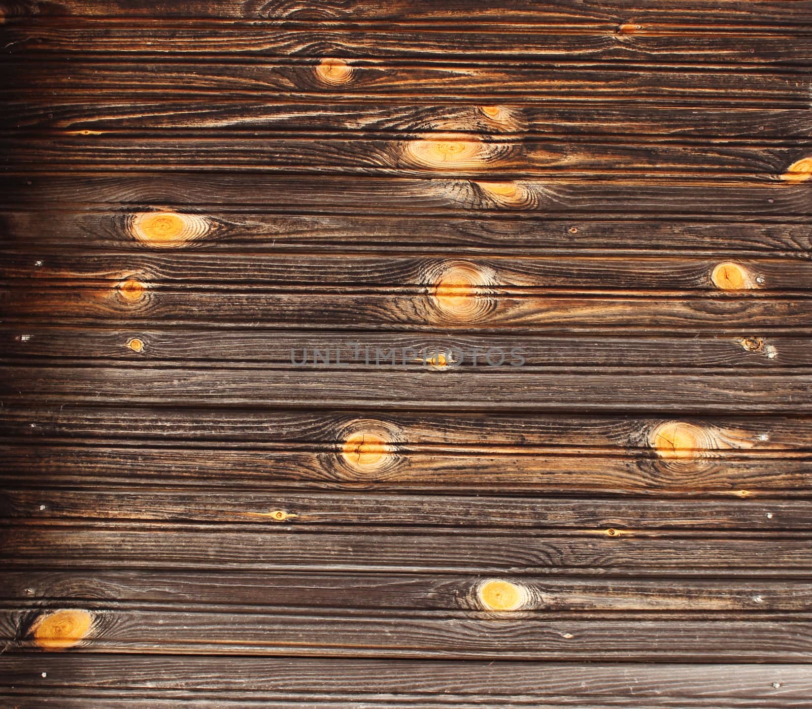 The texture of pure wood on the wall of an ordinary old wooden house, village Nizovskaya, Leningrad region, Russia.