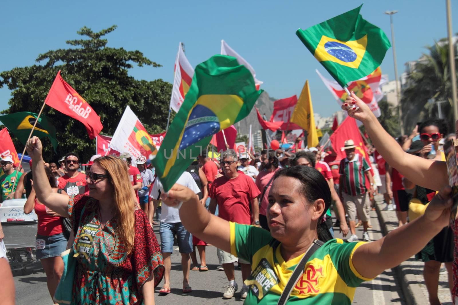 BRAZIL, Rio de Janeiro: Protesters wave flags at a rally on Copacabana Beach in Rio de Janeiro, Brazil on April 17, 2016, against the impeachment of President Dilma Rousseff. Rousseff faces an impeachment vote today over charges of manipulating government accounts. Brazil's lower house is voting on whether to continue impeachment proceedings. 342 out of 513 votes are needed to continue the proceedings to the upper house.