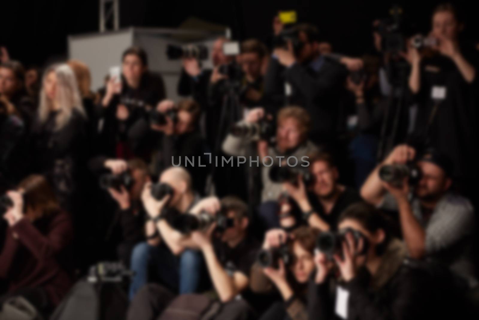 Abstract blurred photographer and reporter at fashion show