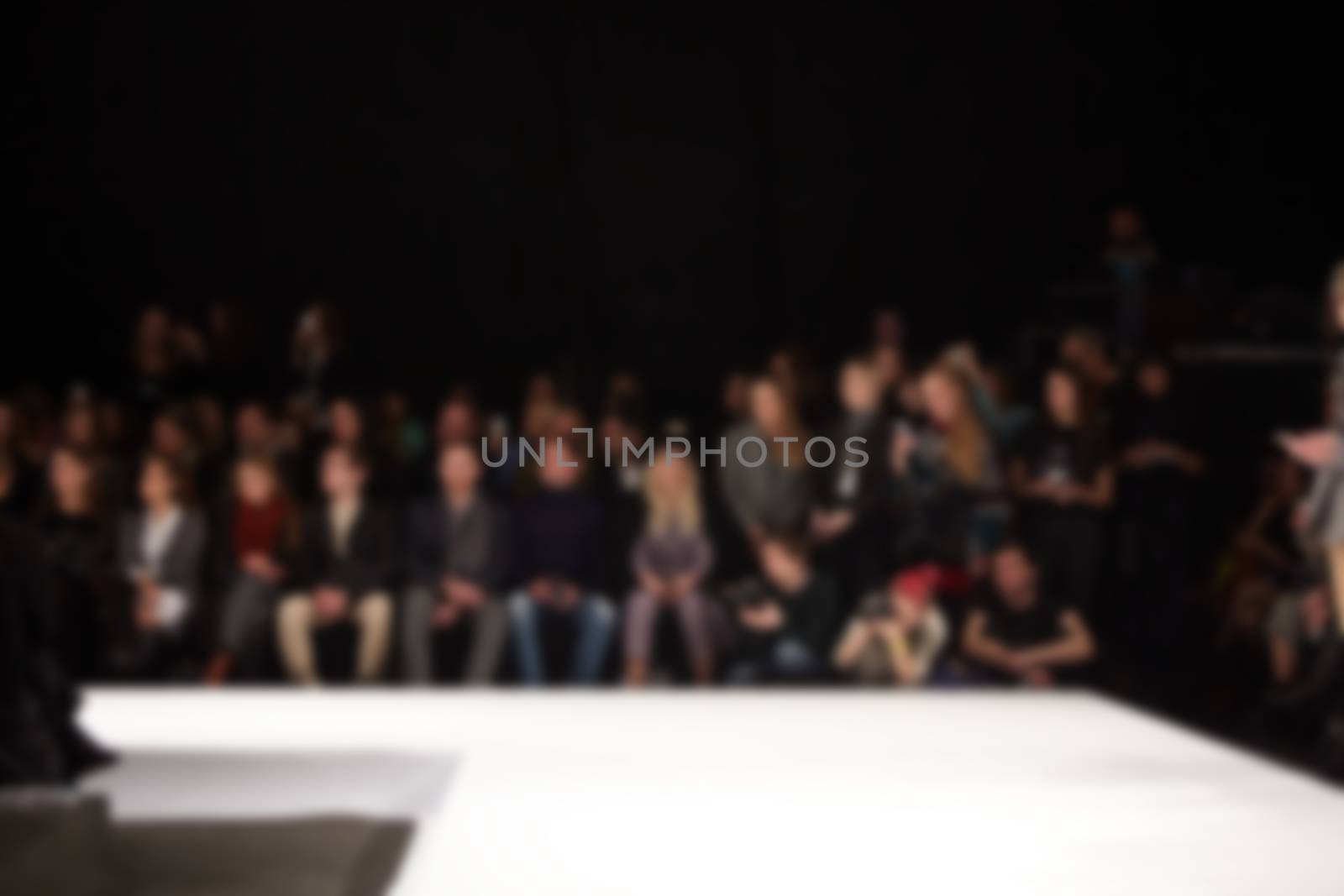 blurred image of group audience at fashion show stage by sarymsakov