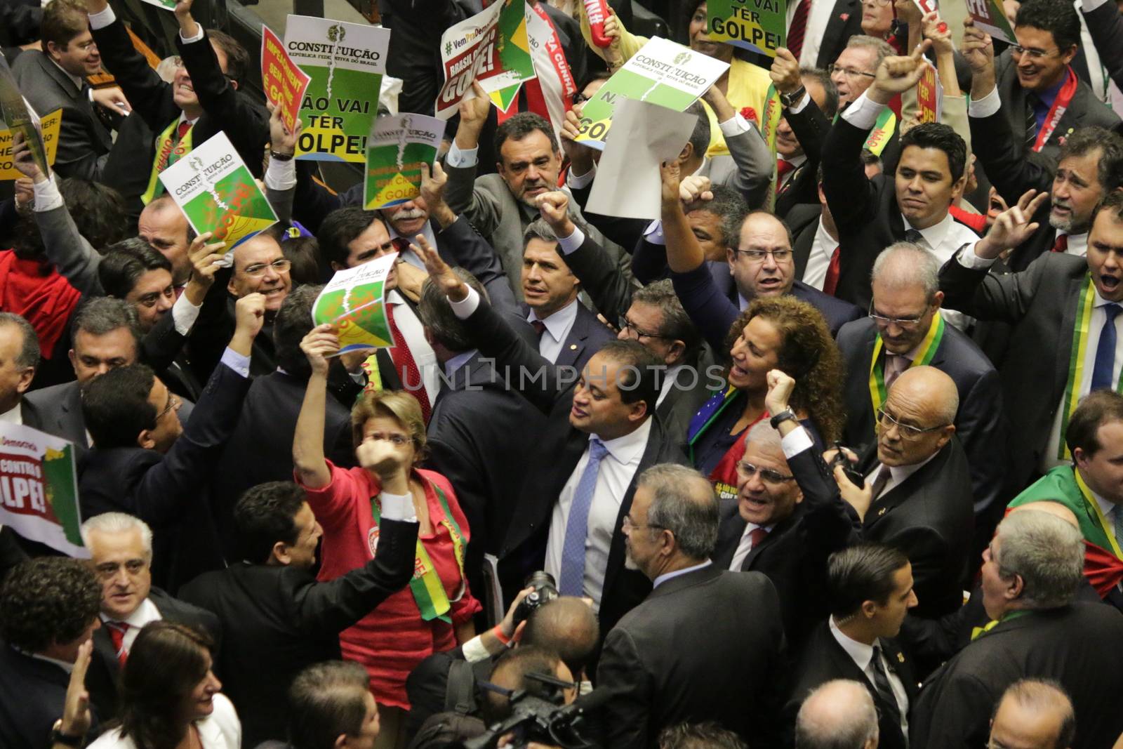 BRAZIL, Brasilia: Members of parliament hold up signs during the impeachment proceedings for President Dilma Rousseff on April 17, 2016 in Brasilia. Some members of parliament began signing, shouting and throwing confetti as the proceedings turned chaotic. The impeachment issue has divided Brazil over the past few weeks with some in support of impeaching Rousseff, while others are strongly opposed. Brazil's lower house is voting on whether to continue impeachment proceedings. 342 out of 513 votes are needed to continue the proceedings to the upper house.