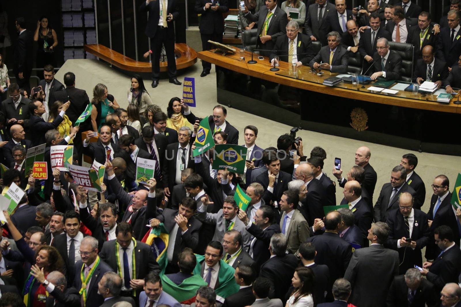 BRAZIL, Brasilia: Members of parliament began impeachment proceedings for President Dilma Rousseff on April 17, 2016 in Brasilia. Some members of parliament began signing, shouting and throwing confetti as the proceedings turned chaotic. The impeachment issue has divided Brazil over the past few weeks with some in support of impeaching Rousseff, while others are strongly opposed. Brazil's lower house is voting on whether to continue impeachment proceedings. 342 out of 513 votes are needed to continue the proceedings to the upper house.