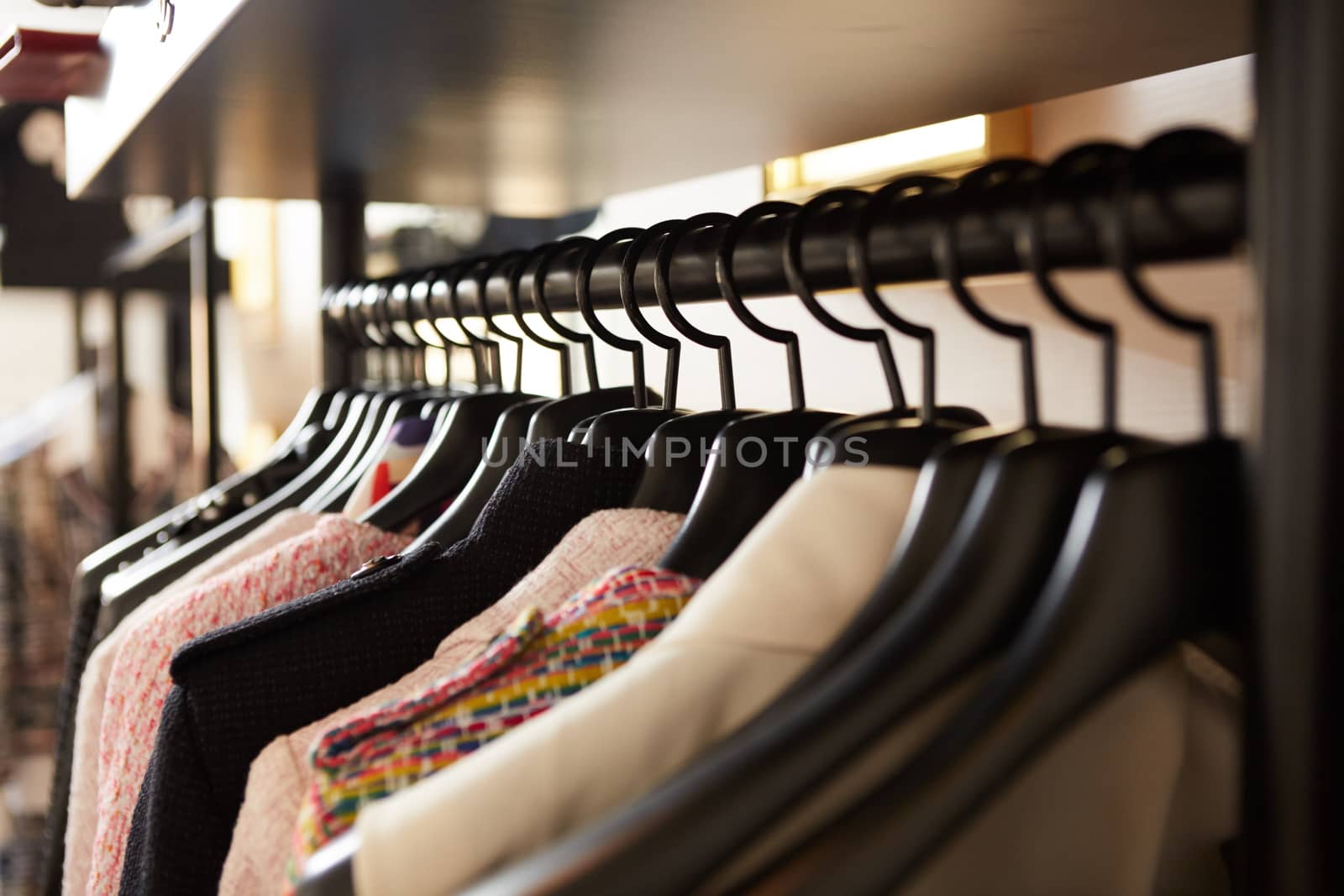 Clothes on hangers in shop. Close up. Shallow dof
