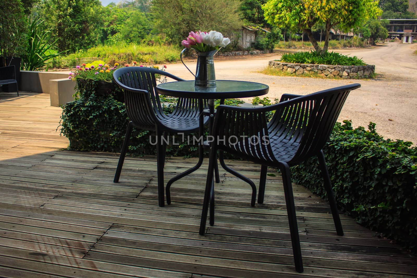 Outdoor furniture of tables and chairs with flowerpot by worrayuth