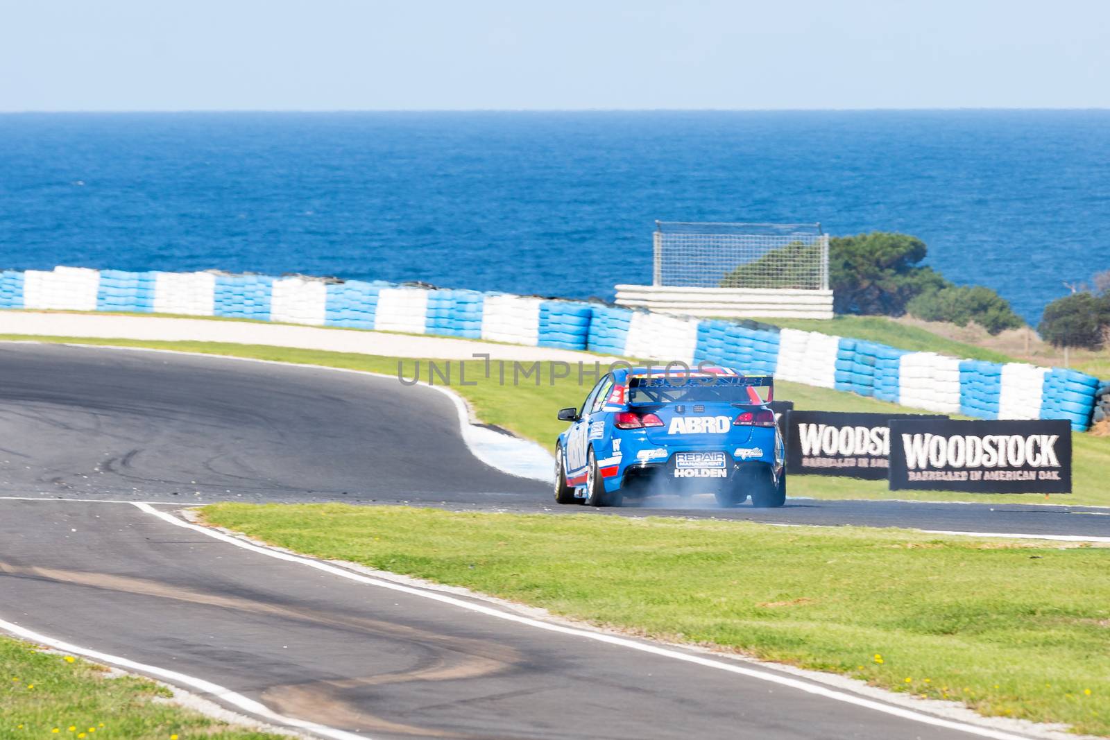 PHILLIP ISLAND, MELBOURNE/AUSTRALIA - 17 APRIL 2016: Nick Percat's Holden Commodore suffers mechanical damage coming into turn 6 at Phillip Island.