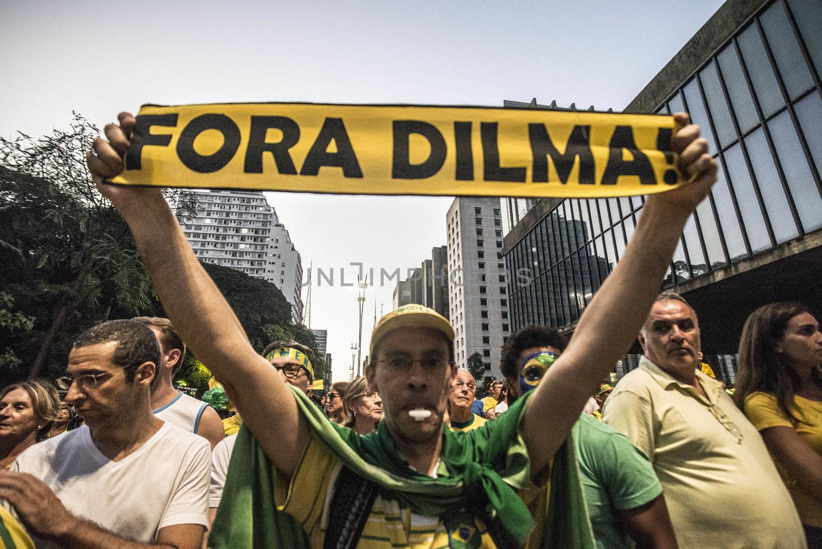 BRAZIl, Sao Paulo: A man holds a placard which reads Dilma out! as thousands of activists supporting the impeachment of President Dilma Rousseff take part in a protest in Sao Paulo, on April 17, 2016. Brazilian lawmakers on Sunday reached the two thirds majority necessary to authorize impeachment proceedings against President Dilma Rousseff. The lower house vote sends Rousseff's case to the Senate, which can vote to open a trial. A two thirds majority in the upper house would eject her from office. Rousseff, whose approval rating has plunged to a dismal 10 percent, faces charges of embellishing public accounts to mask the budget deficit during her 2014 reelection.