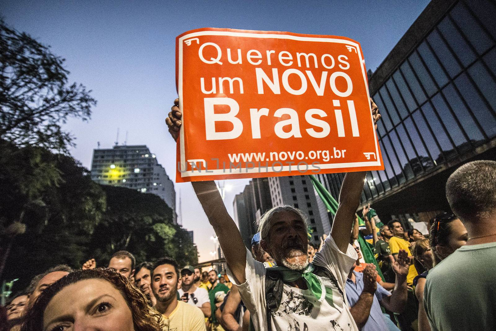 BRAZIl, Sao Paulo: A man holds a placard which reads We want a new Brazil! as thousands of activists supporting the impeachment of President Dilma Rousseff take part in a protest in Sao Paulo, on April 17, 2016. Brazilian lawmakers on Sunday reached the two thirds majority necessary to authorize impeachment proceedings against President Dilma Rousseff. The lower house vote sends Rousseff's case to the Senate, which can vote to open a trial. A two thirds majority in the upper house would eject her from office. Rousseff, whose approval rating has plunged to a dismal 10 percent, faces charges of embellishing public accounts to mask the budget deficit during her 2014 reelection.