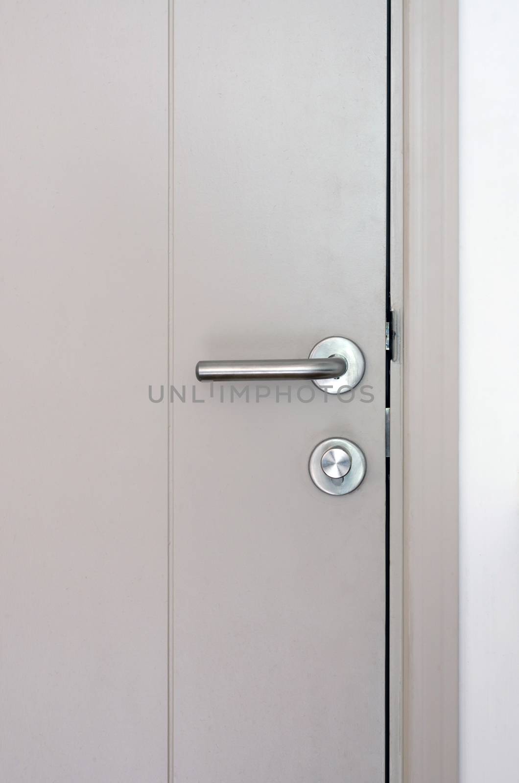Modern style door handle and lock on grey door
