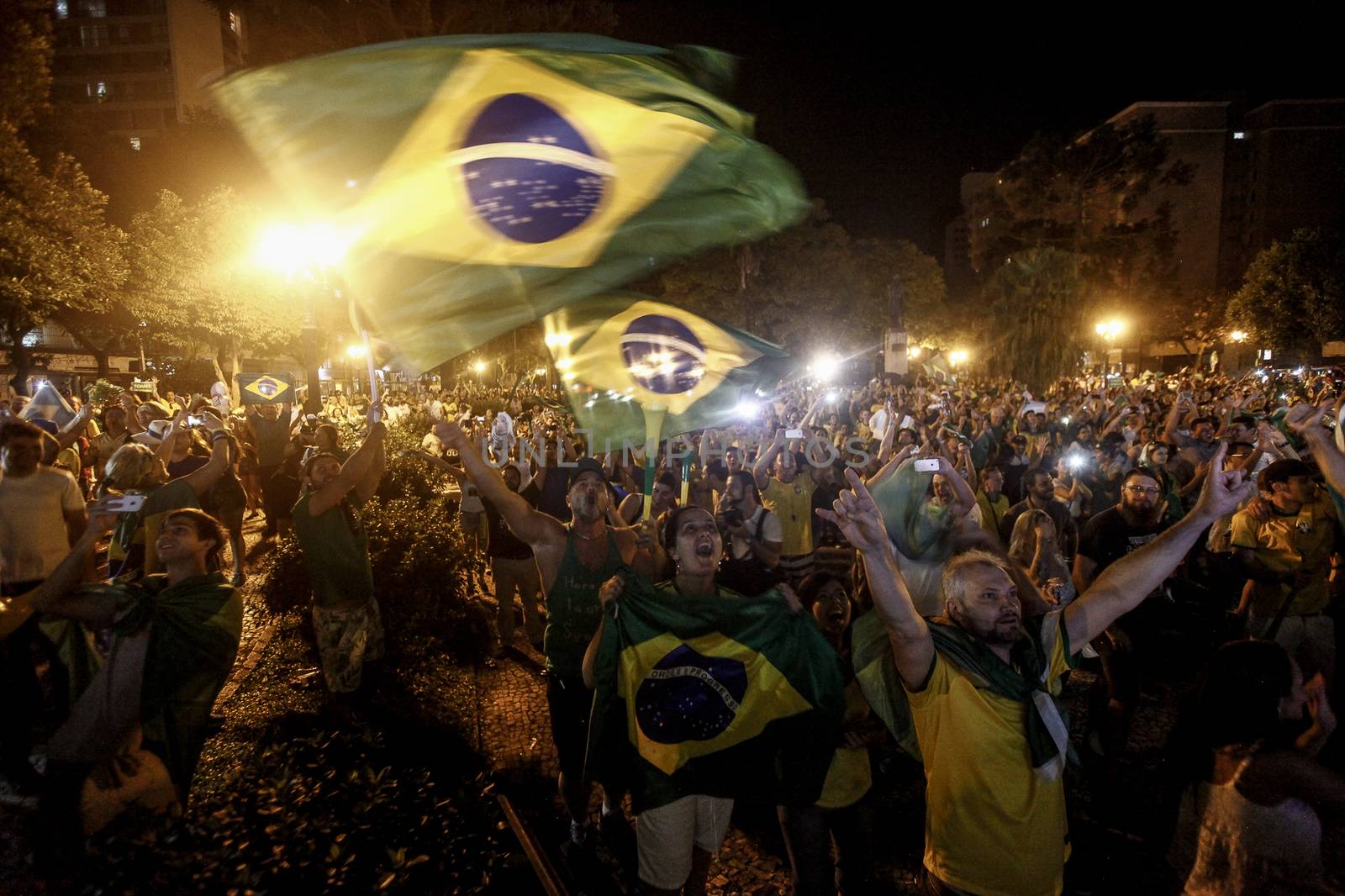 BRAZIL, Curitiba: Activists supporting the impeachment of Brazilian President Dilma Rousseff follow on a big screen as lawmakers vote on whether the impeachment of Rousseff will move forward, in Curitiba, southern Brazil, on April 17, 2016. Brazilian lawmakers on Sunday reached the two thirds majority necessary to authorize impeachment proceedings against President Dilma Rousseff. The lower house vote sends Rousseff's case to the Senate, which can vote to open a trial. A two thirds majority in the upper house would eject her from office. Rousseff, whose approval rating has plunged to a dismal 10 percent, faces charges of embellishing public accounts to mask the budget deficit during her 2014 reelection.