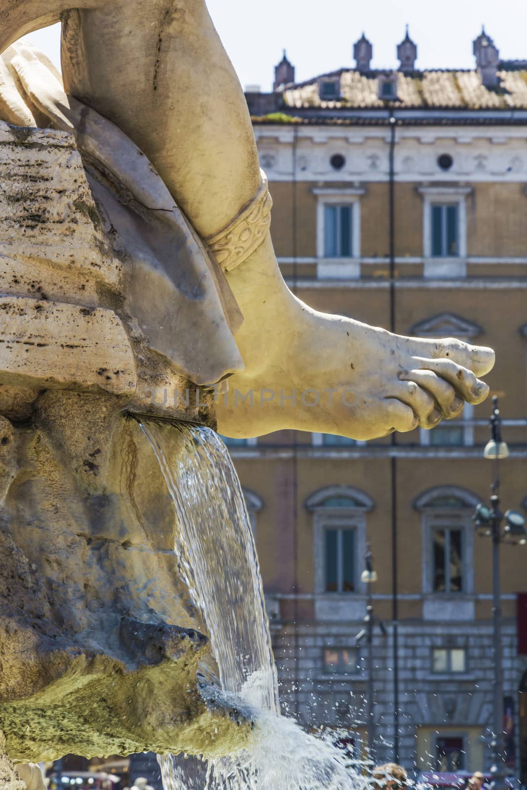 the marble foot of Rio de la Plata statue with gushing water in piazza navona, Rome