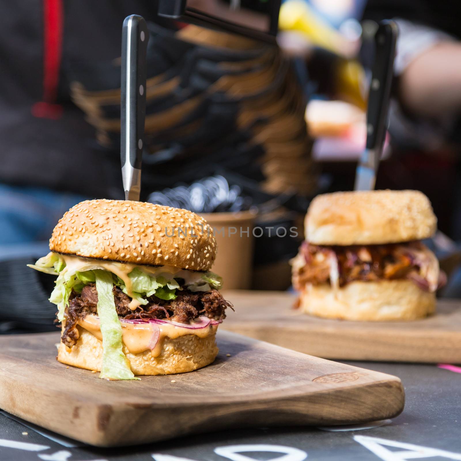 Beef burgers being served on street food stall by kasto