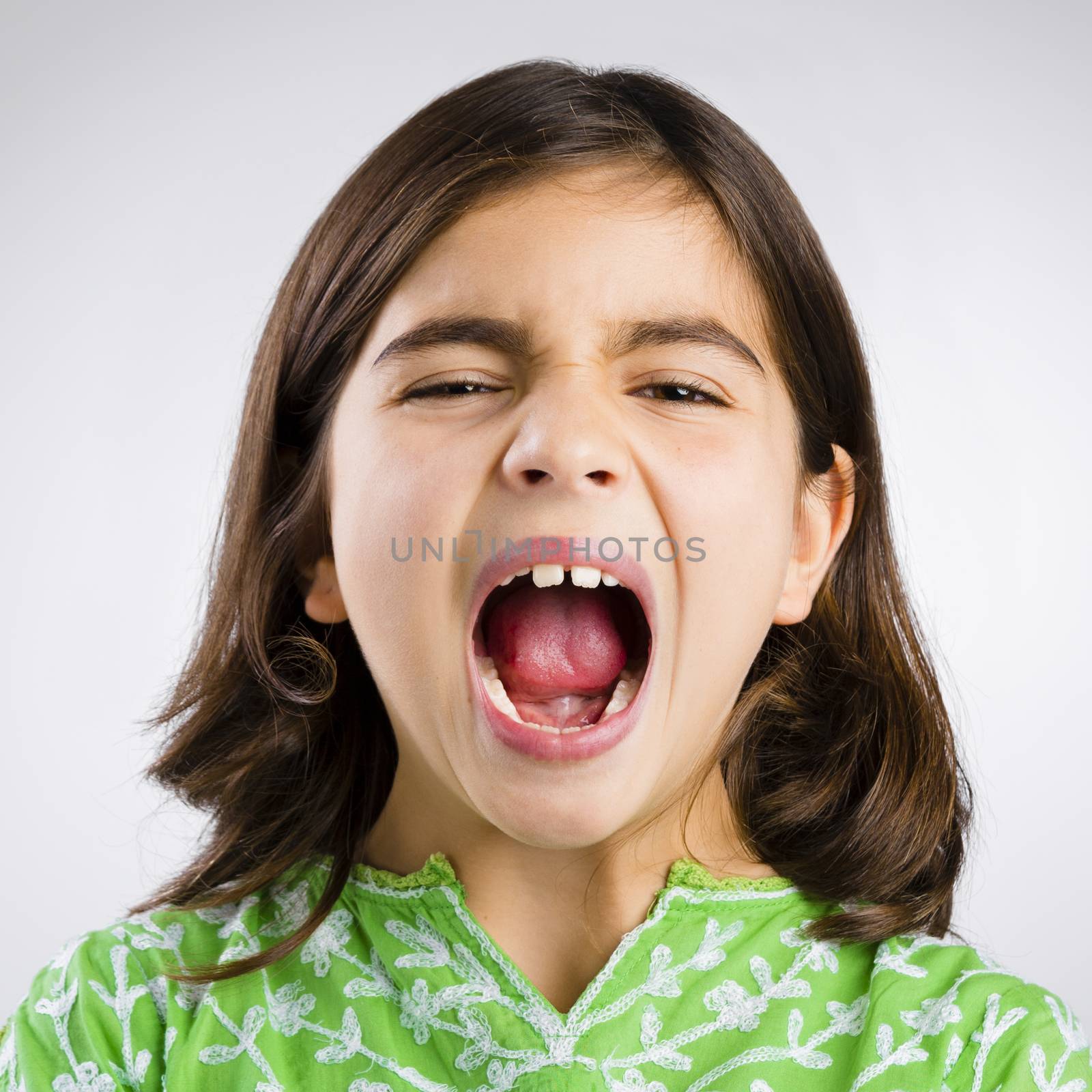 Portrait of a little girl shouting loud