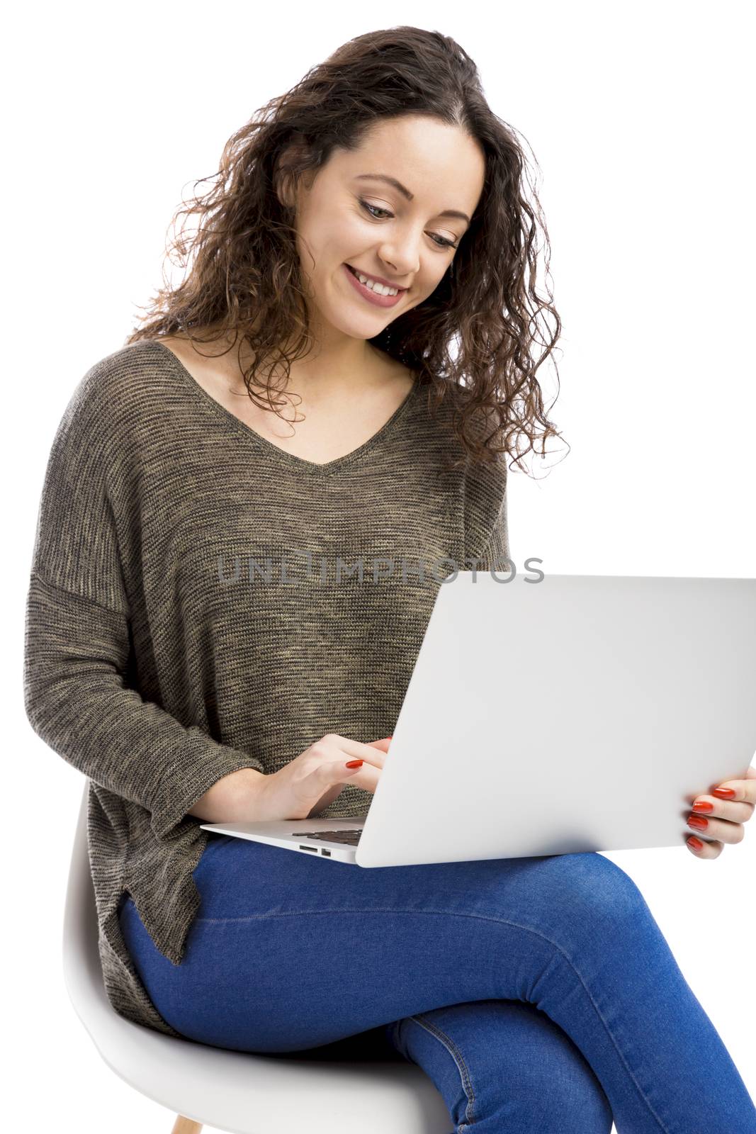 Beautiful and happy woman working with a laptop, isolated over white background 