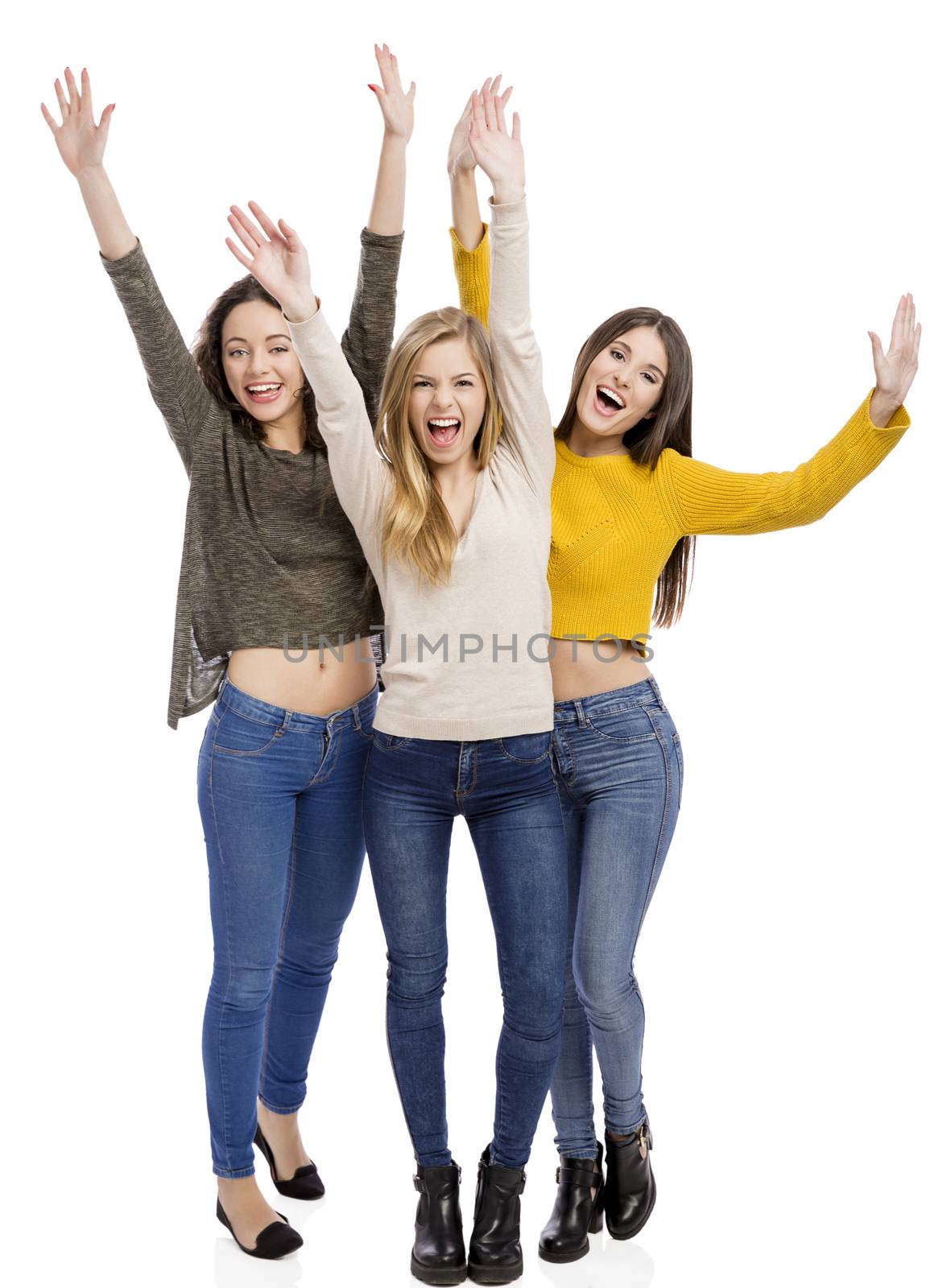 Studio portrait of three happy teenage girl 