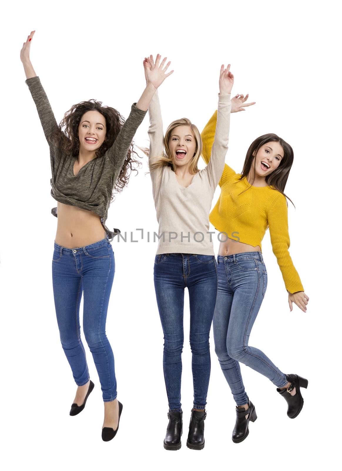 Studio portrait of three happy teenage girl 