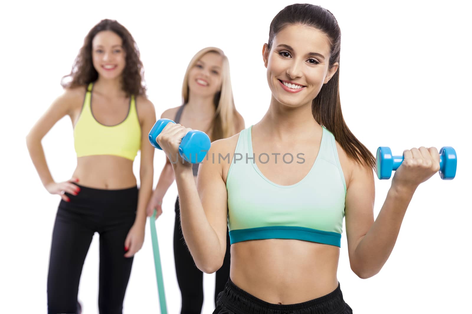 Portrait of three beautiful athletic girls in the gym