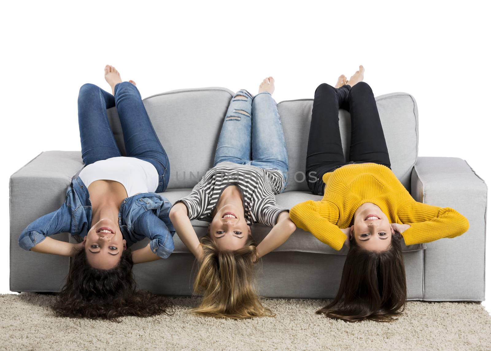 Happy teen girls at home sitting on the couch