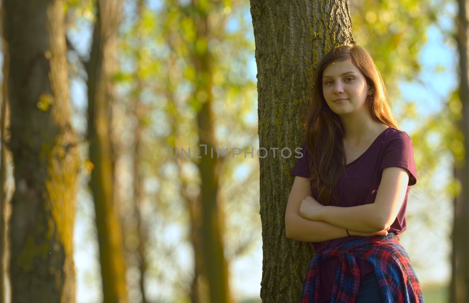 Portrait of a Pretty Teen Girl Standing in a Forest