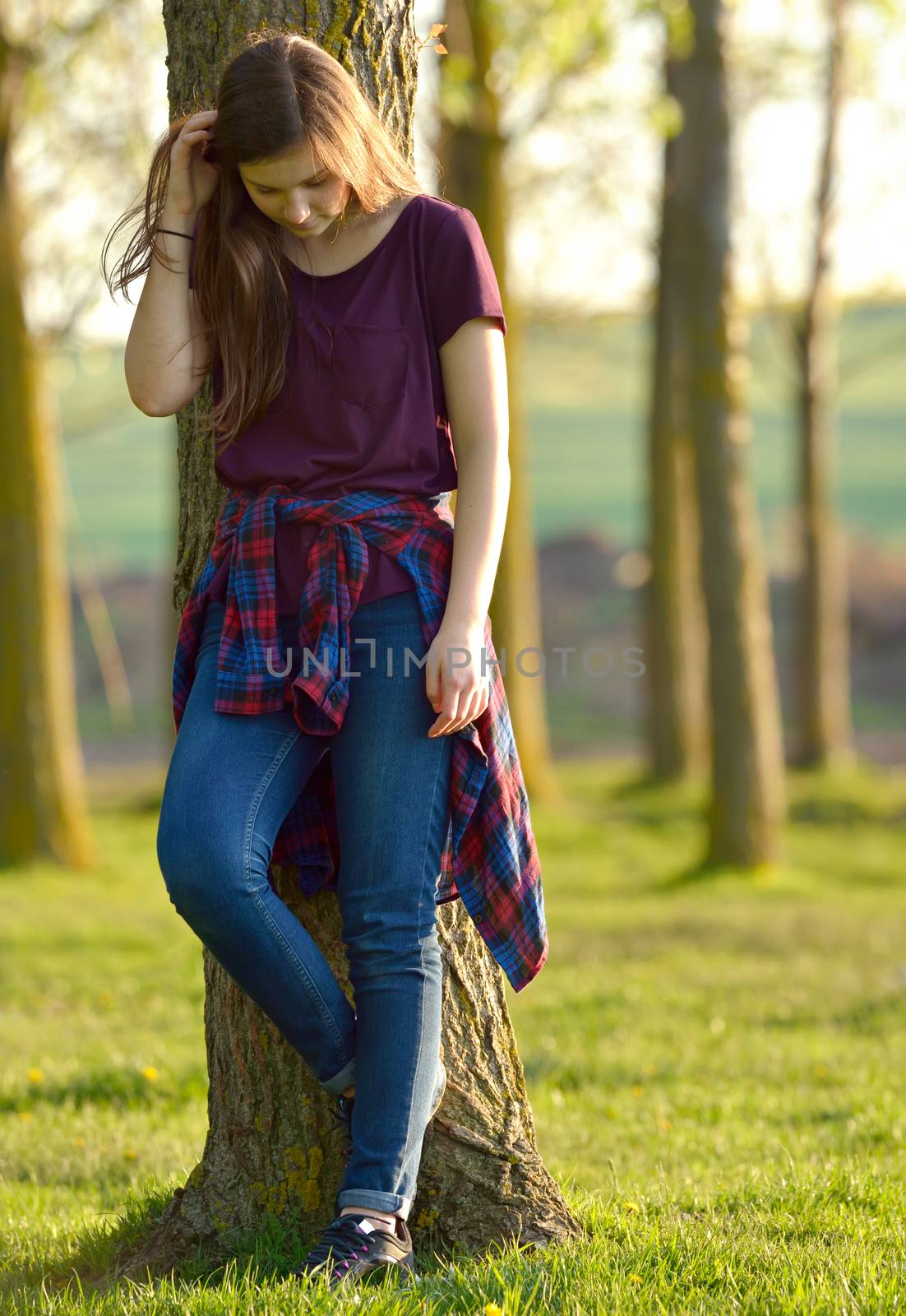 Portrait of a Pretty Teen Girl Standing in a Forest