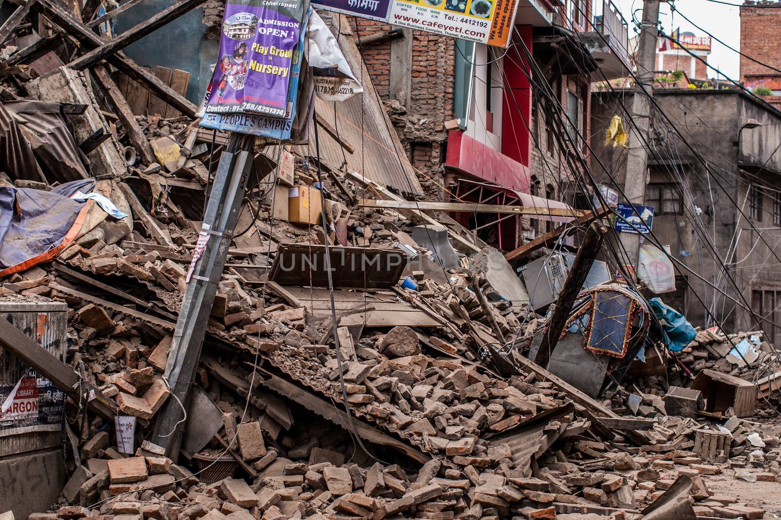 NEPAL,Kathmandu: A collapsed building covers the street after being destroyed by a large earthquake on April 25, 2015.More than 8,000 people died in the quake and some 3.5 million were left homeless. 