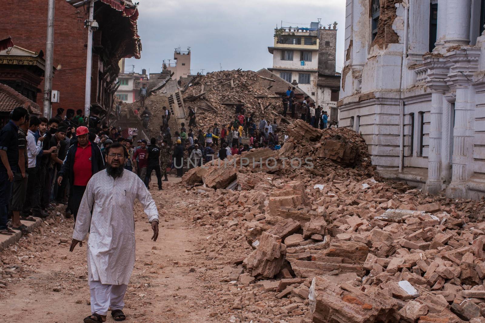NEPAL,Kathmandu: People walk in the rubble in Kathmandu's Durbar Square on April 25, 2015, after a magnitude 7.8 earthquake hit the area.More than 8,000 people died in the quake and some 3.5 million were left homeless. 