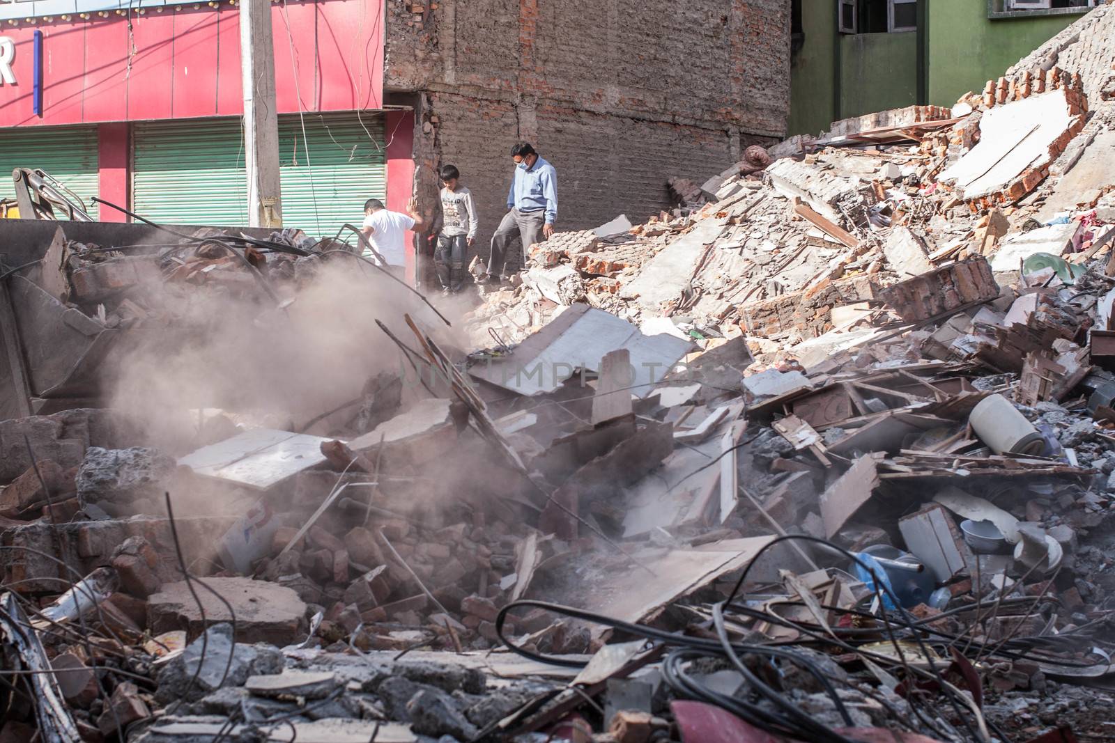 NEPAL,Kathmandu: A collapsed building covers the Naya Bazar Marg road in Kathmandu, Nepal on May 12, 2015, after being destroyed by a large earthquake.More than 8,000 people died in the quake and some 3.5 million were left homeless. 
