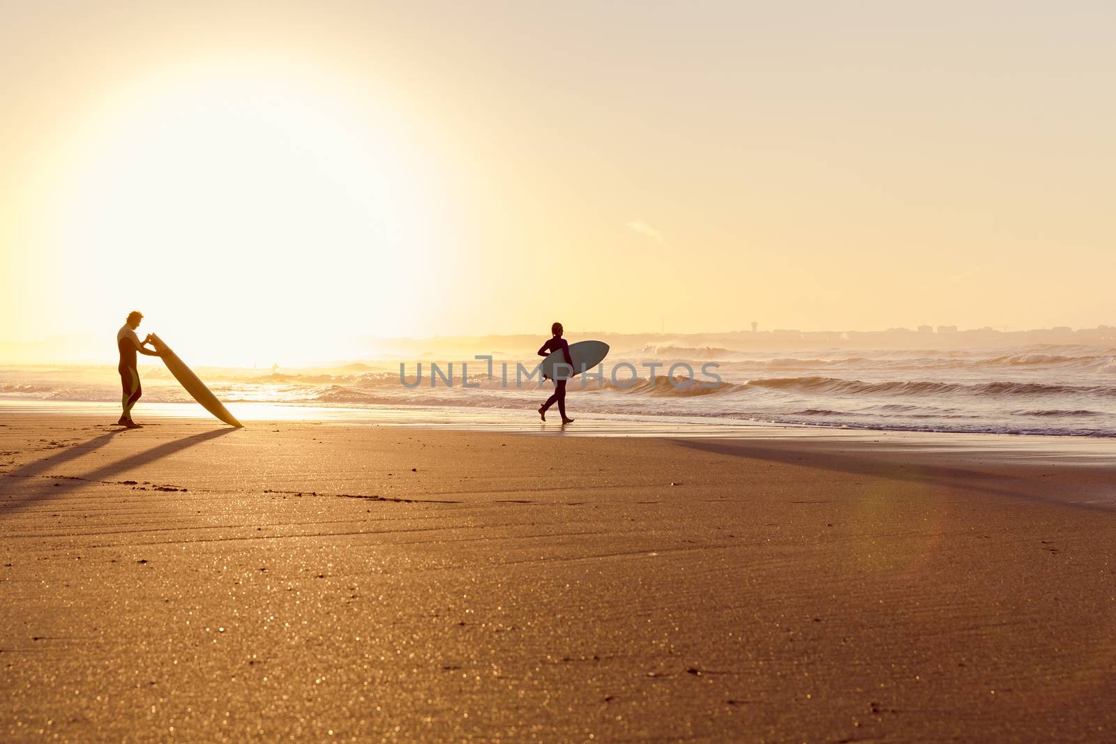 Beautiful beach lansdscape with surfers ready to hit the waves