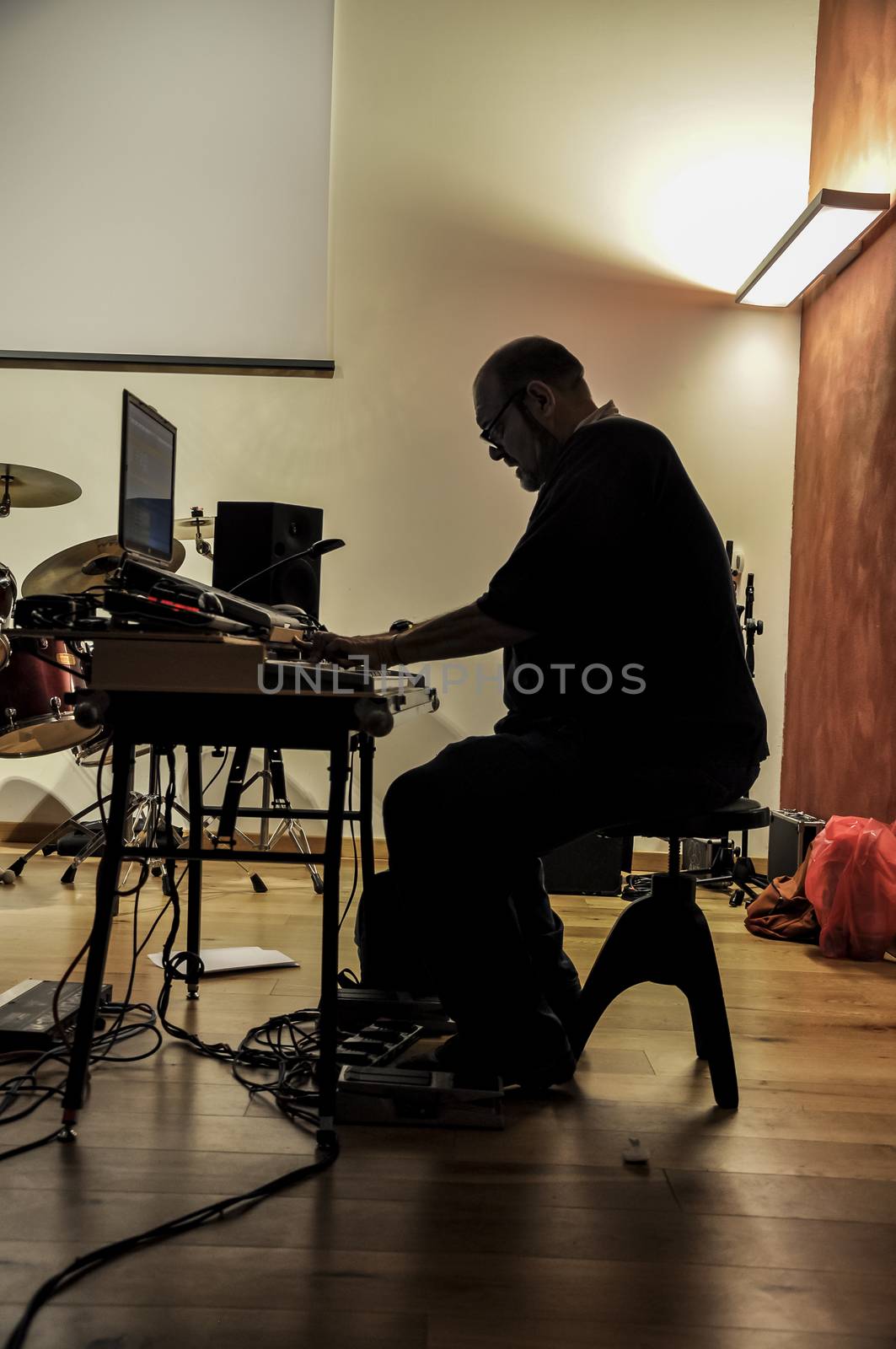 Musician playing on keyboards in a music studio 