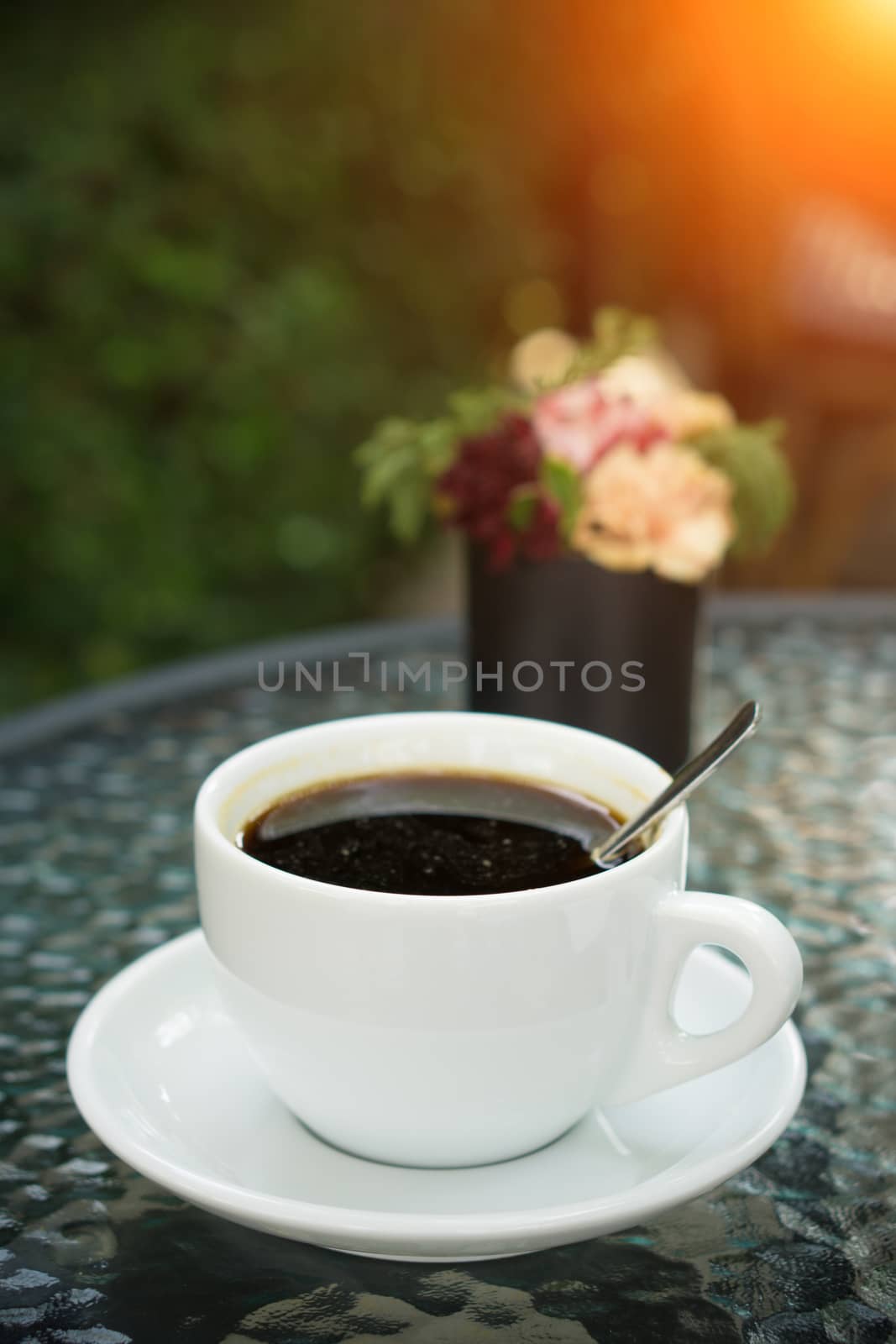 A cup of americano Coffee in coffee shop - vintage and sunlight style effect