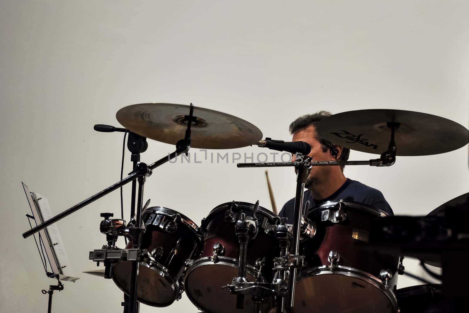 Drummer play rock drums and microphone in focus. Rock music concept