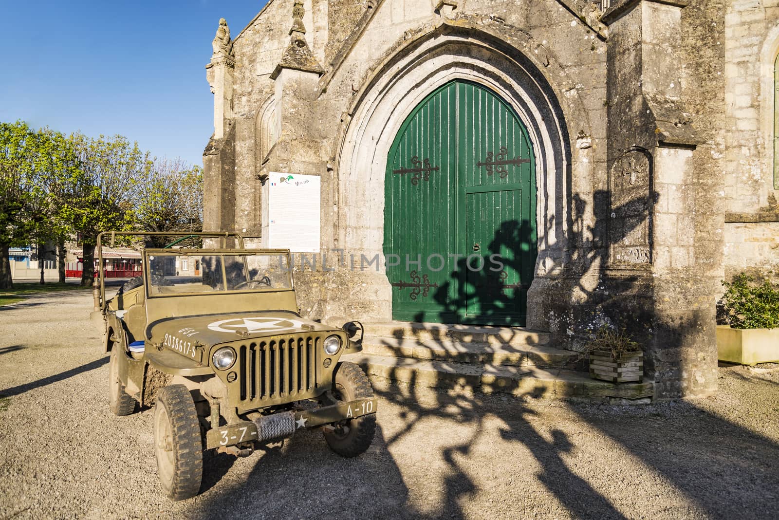 Church and america Jeep in Sainte Marie du Mont, Manche, Normandy, France