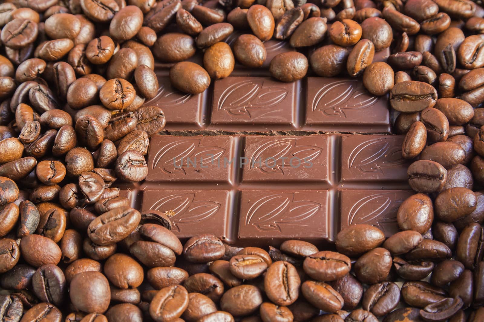 chocolate and coffee beans are roasted Brown background