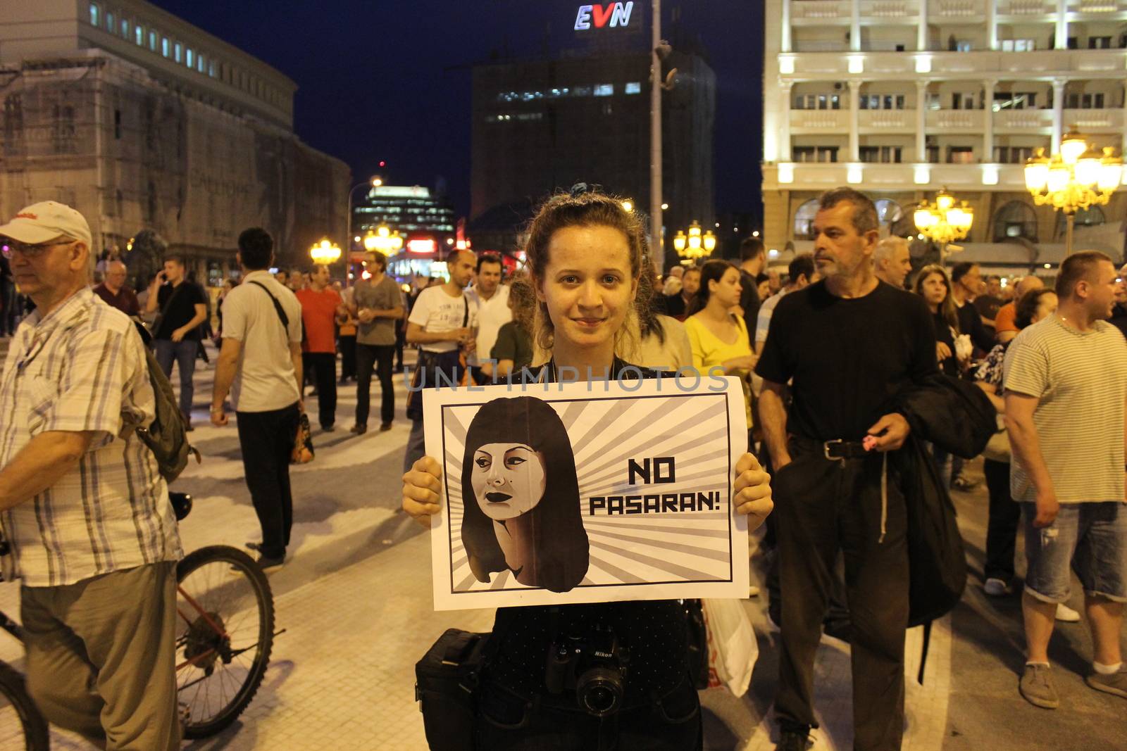 MACEDONIA, Skopje: A protester stands among many as demonstrations continue in Skopje, Macedonia on April 18, 2016. The protests began nearly one week ago, as protesters denounced the President Gjorge Ivanov's decision to halt probes into more than 50 public figures involved in a wiretapping scandal. Meanwhile, snap elections have been called for June 5.