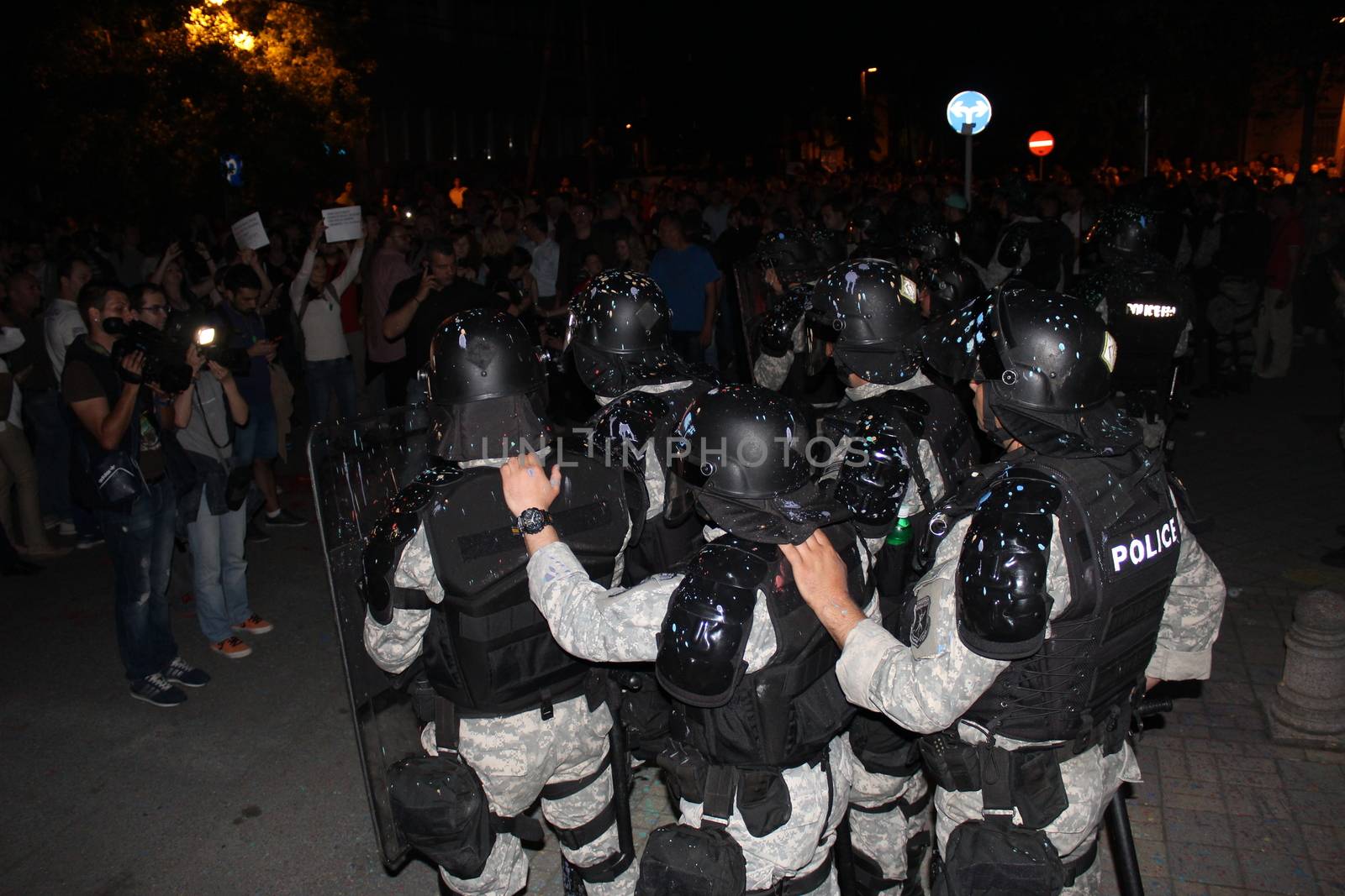 MACEDONIA, Skopje: As demonstrations continue in Skopje, Macedonia on April 18, 2016, huddling police are splattered with paint thrown by angry protesters, who also threw paint and eggs on the Ministry of Culture building. Demonstrations began nearly one week ago, as protesters denounced the President Gjorge Ivanov's decision to halt probes into more than 50 public figures involved in a wiretapping scandal. Meanwhile, snap elections have been called for June 5.