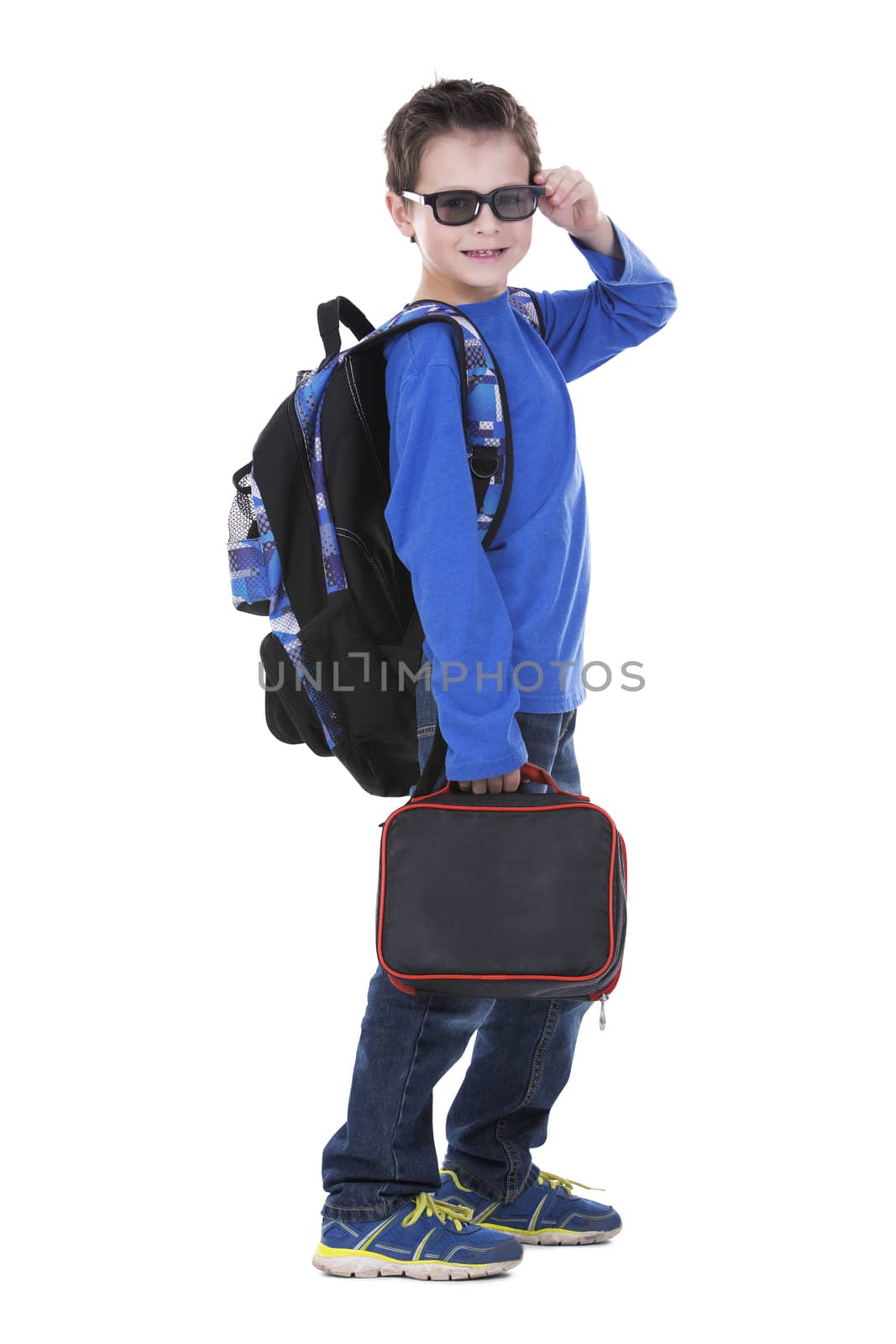 casual boy is holding an apple and school lunch on white background