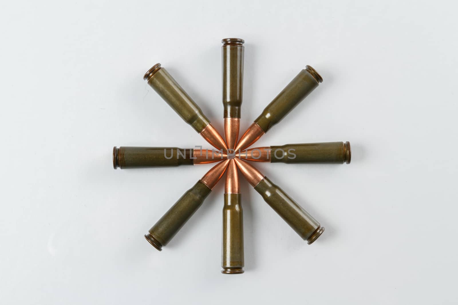 Eight 7.62x39 target shooting rifle cartridges arranged in a symmetrical star shape